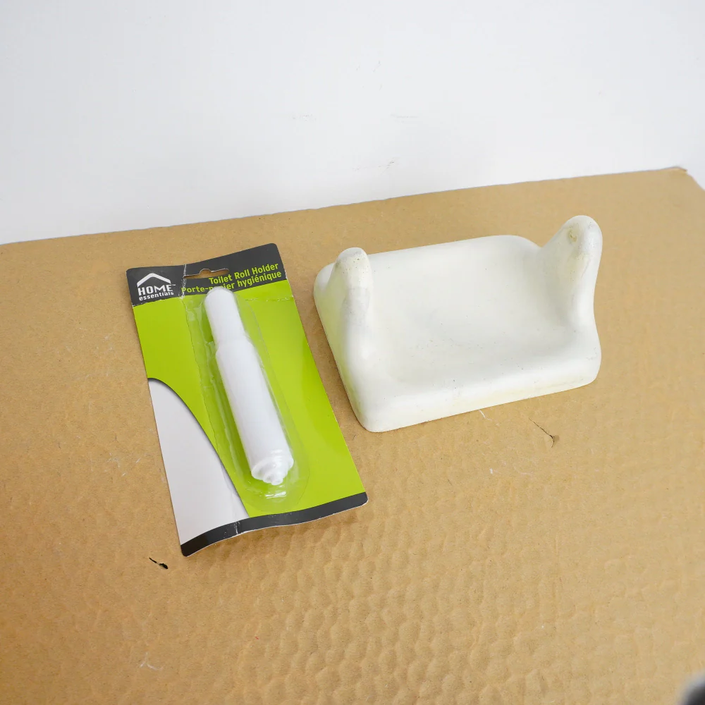 Porcelain Wall-Mount Toilet Paper Holder in Blanco White